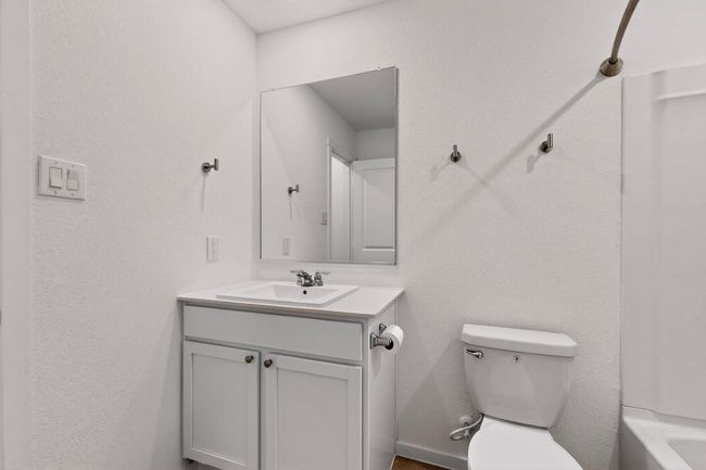 Full bathroom with vanity, toilet, and a bathtub | Image 14