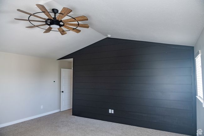 Bonus room with lofted ceiling, a ceiling fan, and carpet | Image 13
