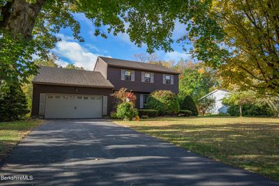 generously sized front lawn, black top driveway. | Image 3