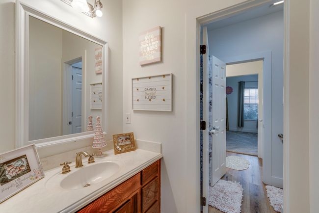 Bathroom featuring LVP flooring, vanity, and an inviting chandelier | Image 18