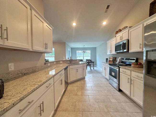 Clothes washing area with electric dryer hookup, laundry area, baseboards, and visible vents | Image 9