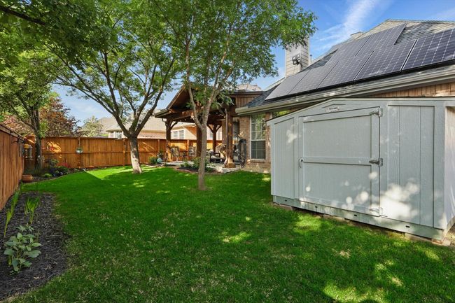 View of yard with a storage shed, an outdoor structure, and a patio | Image 36