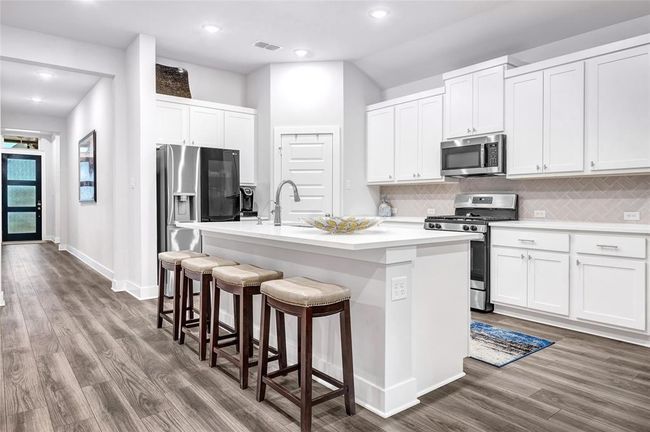 Modern Kitchen over looks Dining and Family Room. | Image 19