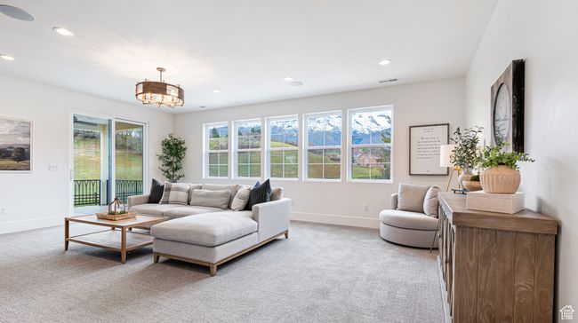 Living area featuring light colored carpet, baseboards, and a healthy amount of sunlight | Image 41
