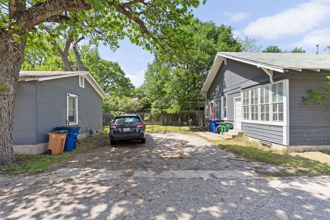 View of side of property featuring entry steps, fence, and aphalt driveway | Image 24
