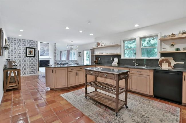 The chef's kitchen is great for cooking while hosting a crowd. Also has plenty of countertop for baking. And the view from that window looks out over your babbling brook. What could be better? | Image 8
