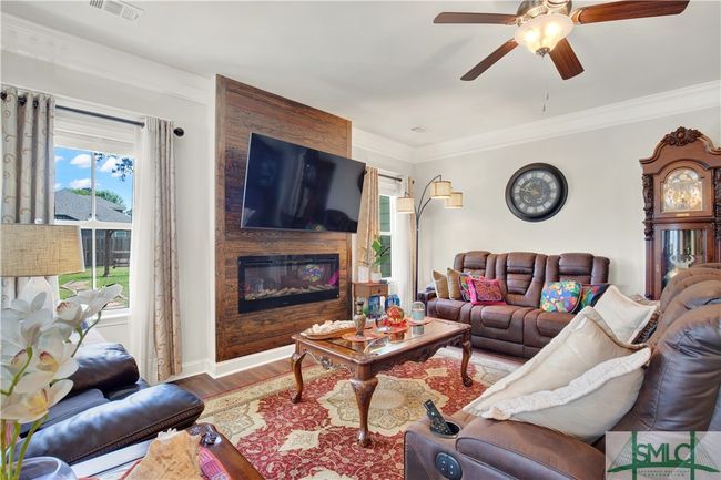 Family Room with shiplap accent wall and electric fireplace | Image 16