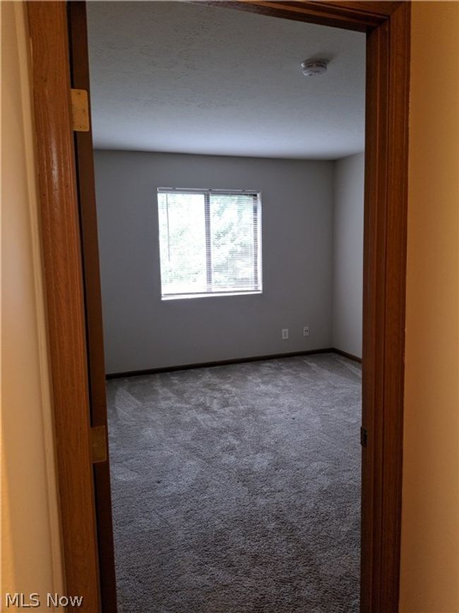 View of carpeted spare room | Image 23