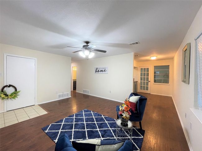 Living area featuring hardwood / wood-style flooring and ceiling fan | Image 7
