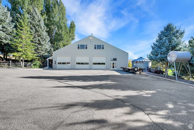Back of house featuring an outbuilding and a garage | Image 36