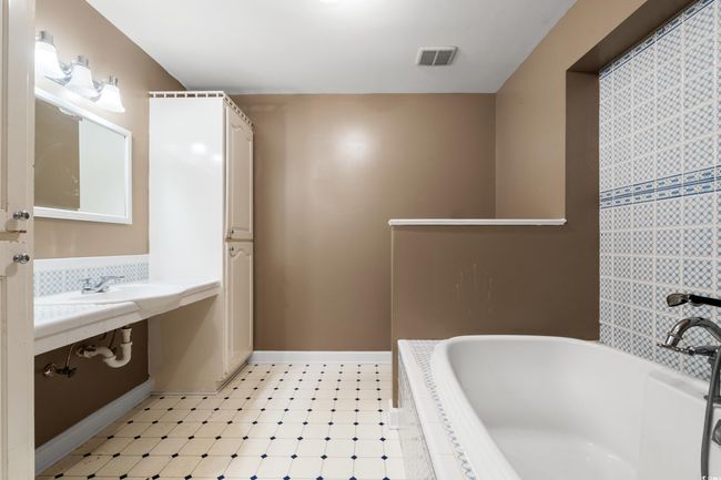 Full bathroom featuring tiled bath and tile patterned floors | Image 26