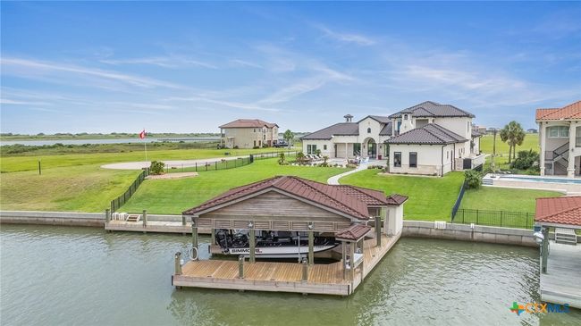 Waterview of the Property with Double Boathouse Boat Lift, Storage Room, Cleaning Table, Fishing Deck, and Boardwalk with Shore Power | Image 41