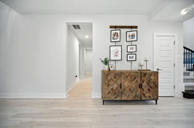 Hall featuring stairs, light wood-style flooring, and recessed lighting | Image 17