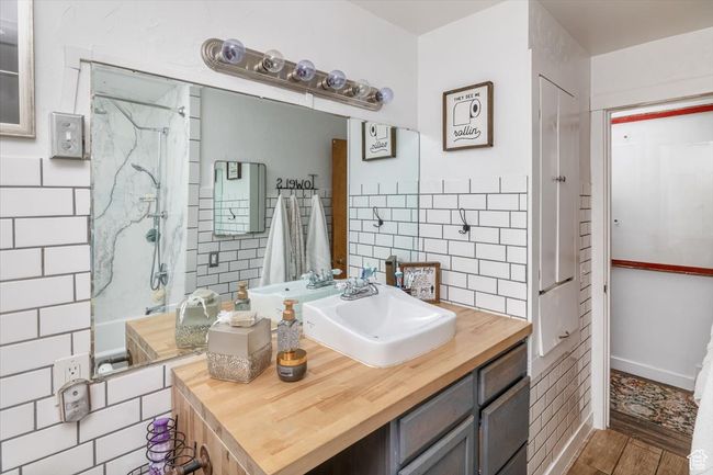 Bathroom featuring tiled shower and vanity | Image 16