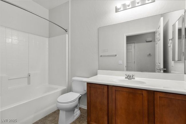 Full bath with vanity, shower / bath combination, and tile patterned floors | Image 36