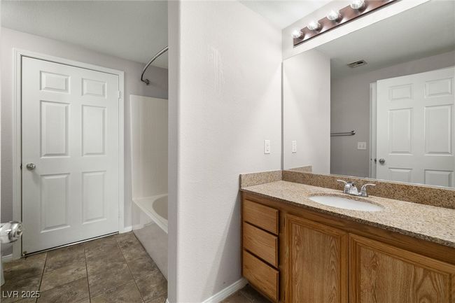 Bathroom with visible vents, vanity, and shower combination | Image 24