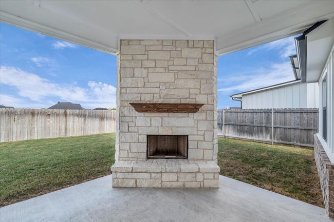 Covered Patio features a Wood Burning Fireplace | Image 31