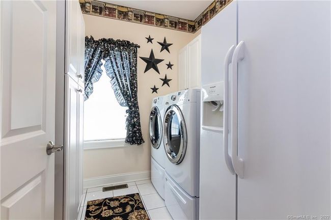 Laundry room adjacent to the kitchen. | Image 10