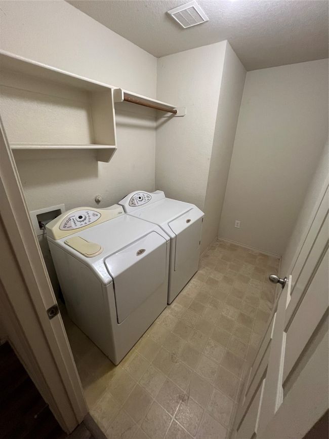 Washroom with separate washer and dryer, light floors, and a textured ceiling | Image 40