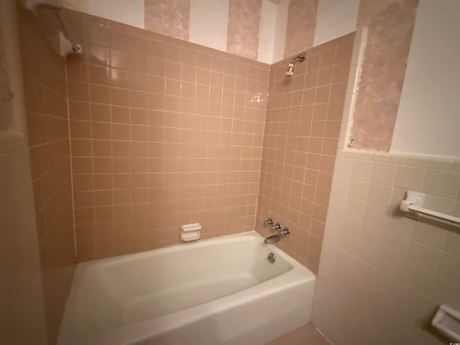 Full bath featuring tile walls and tub / shower combination | Image 10