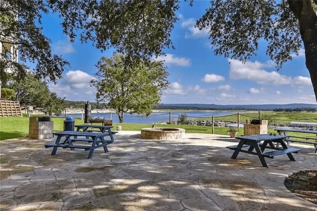 Surrounding community featuring a fire pit, a water view, and a patio | Image 30