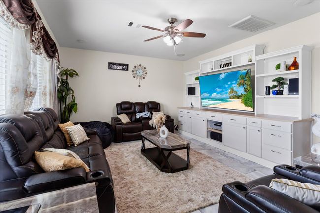 Spacious living room seamlessly flows into the kitchen, perfect for entertaining. | Image 4