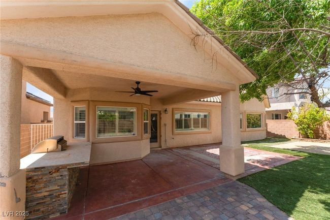 View of patio with ceiling fan and area for grilling | Image 48