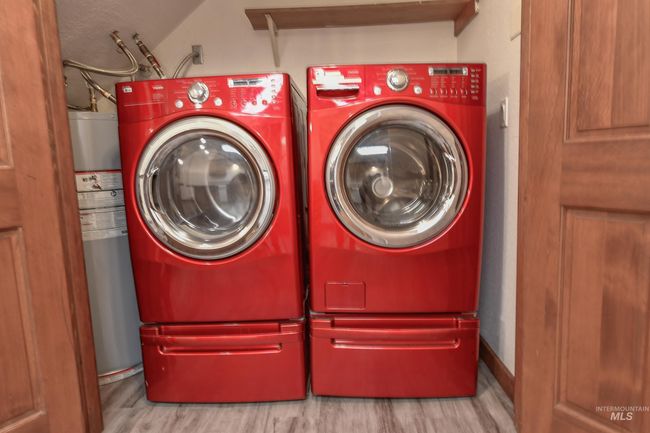 Laundry area with washer and clothes dryer and wood finished floors | Image 13