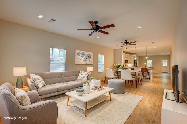 Living area featuring light wood-style floors, recessed lighting, and a ceiling fan | Image 5
