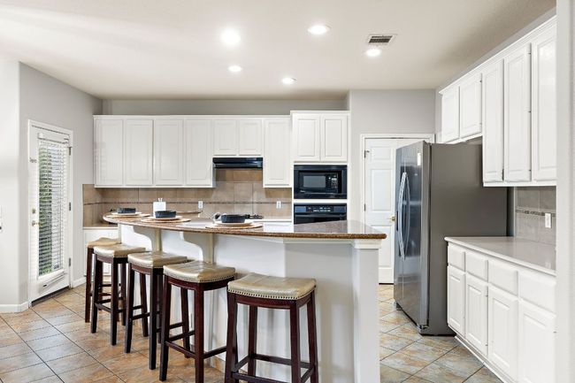The beautiful kitchen has a great breakfast bar! | Image 17