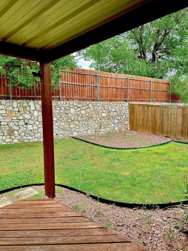 View of yard featuring a fenced backyard and a wooden deck | Image 22