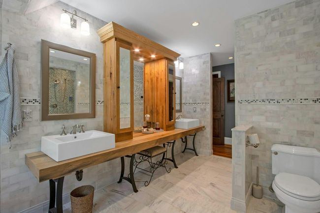 Bathroom featuring tile walls, toilet, recessed lighting, and dual sinks | Image 20