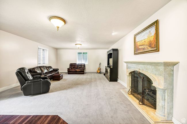 Living room with a high end fireplace and carpet floors | Image 59