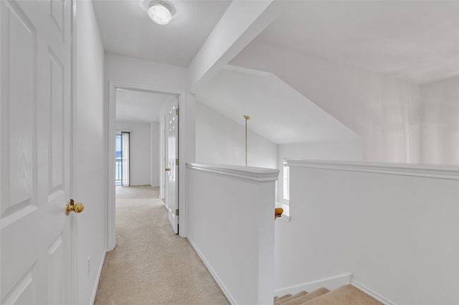 Corridor featuring carpet, an upstairs landing, and vaulted ceiling | Image 17