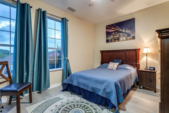 Bedroom featuring light wood-style flooring, baseboards, and ceiling fan | Image 21