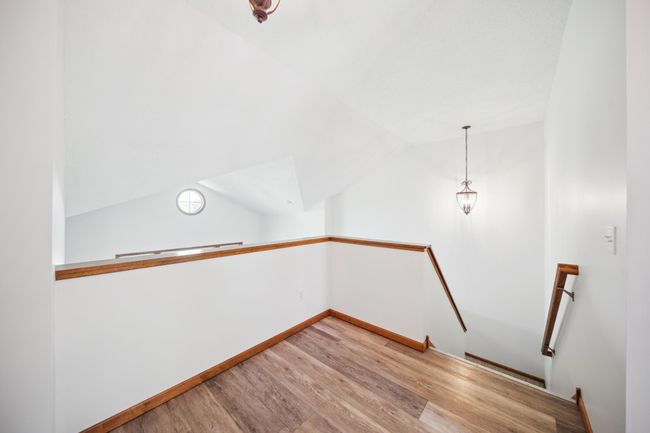 Upstairs are three bedrooms, including a spacious primary suite and laundry. | Image 22