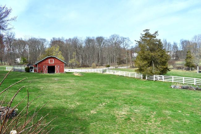 View of backyard from the deck overlooking barn and pasture | Image 33