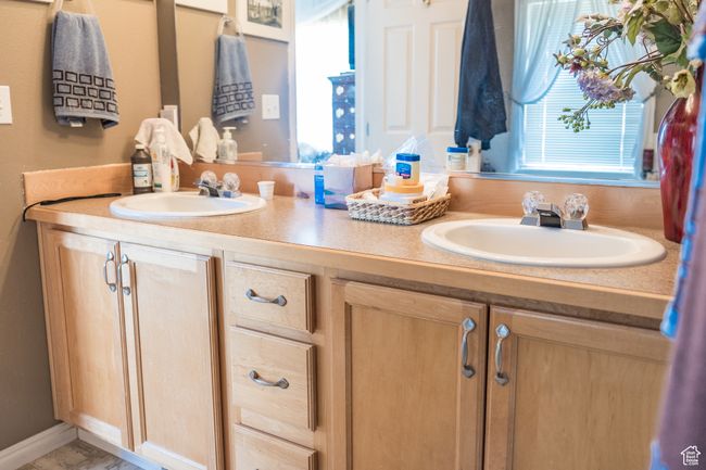 Full bathroom with double vanity, a sink, and a wealth of natural light | Image 15