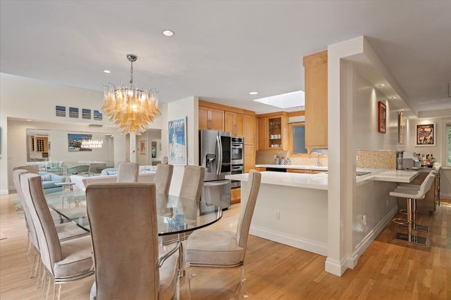 Dining space featuring a chandelier, light wood finished floors, and recessed lighting | Image 4