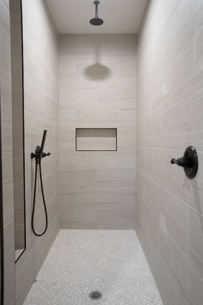 Bathroom featuring a tile shower | Image 19