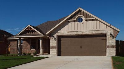 View of front of property with a garage and a front yard | Image 1