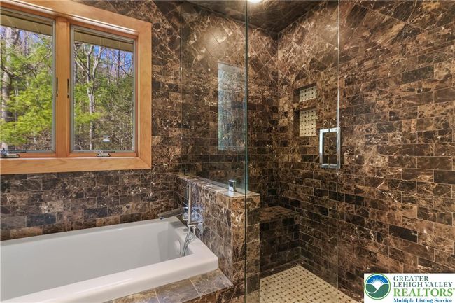 Travertine Tile and a Sumptuous Glass Door Shower and Jetted Tub | Image 46