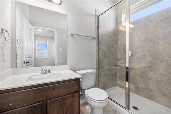 Bathroom featuring a shower stall, vanity, and toilet | Image 17