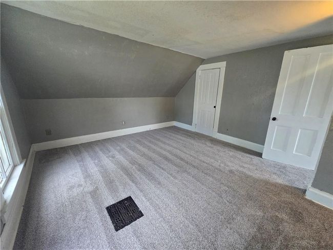 Additional living space featuring carpet floors, lofted ceiling, baseboards, and a textured ceiling | Image 10