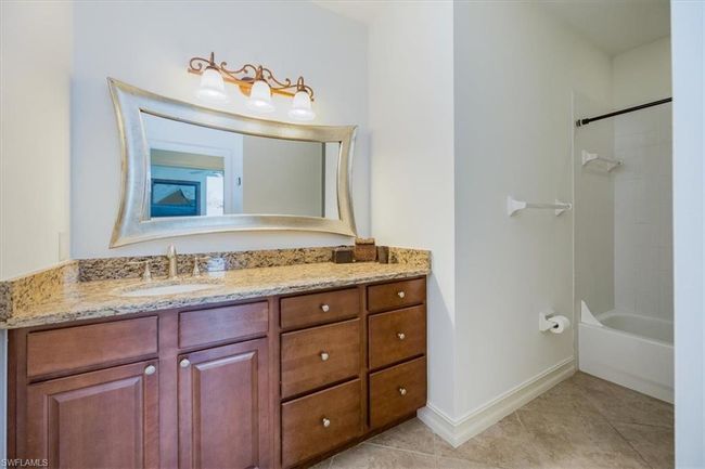Bathroom with tile patterned flooring, vanity, and shower / tub combination | Image 18