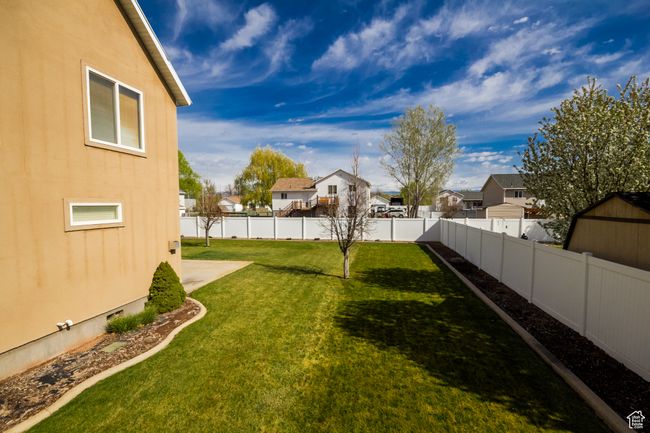 View of yard featuring a fenced backyard and a residential view | Image 29