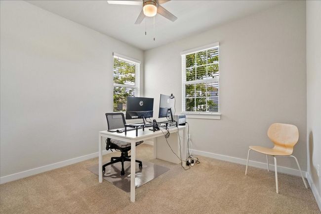 Home office with light colored carpet and ceiling fan | Image 20