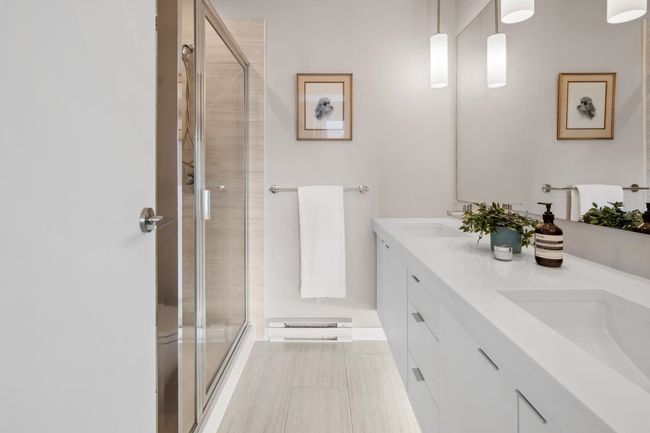 Bathroom with a stall shower and double vanity | Image 26