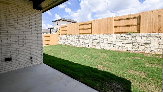 Fenced backyard with a patio area | Image 12