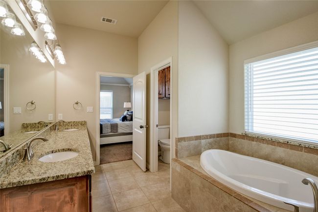 Master Bathroom with toilet, a garden tub, a sink, and ensuite bath | Image 22